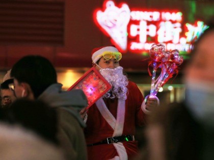 This photo taken on December 24, 2019 shows a vendor dressed as Santa Claus selling toys on a street in Shenyang in China's northeastern Liaoning province. (Photo by STR / AFP) / China OUT (Photo by STR/AFP via Getty Images)