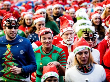 People take part in an Ugly Christmas Sweater Run on December 16, 2017 in The Vondelpark i
