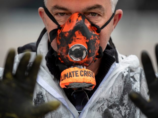 MADRID, SPAIN - DECEMBER 08: A demonstrator wears a mask reading 'Climate Crisis' during a