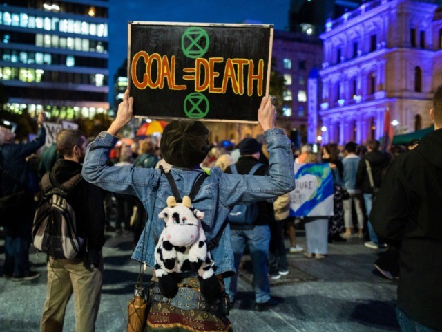 BRISBANE, AUSTRALIA - JULY 05: An Adani protester is seen holding a placard in Brisbane Sq