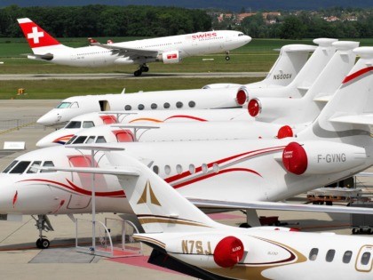 A passenger plane of Swiss International Air Lines takes off behind Dassault's Falcon business jets displayed during the press day of the 8th Annual European Business Aviation Convention & Exhibition (EBACE) on May 19, 2008 in Geneva's International Airport. The annual meeting place for the European business aviation community showcases …
