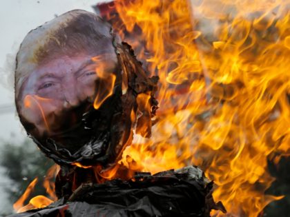 Indian activists of Socialist Unity Center of India-Marxist burn an effigy of U.S. President Donald Trump during a protest in Kolkata, India, Saturday, June 23, 2018. Bowing to pressure from anxious allies, President Donald Trump abruptly reversed himself Wednesday and signed an executive order halting his administration's policy of separating …