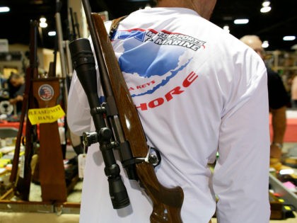 A gun buyer carries a Browning Able rifle on his back while shopping at a gun show hosted by Florida Gun Shows, Saturday, Jan. 9, 2016, in Miami. Schlesinger purchased an Uzi and a Smith & Wesson 38. (AP Photo/Lynne Sladky)