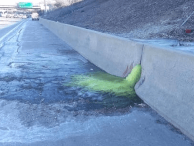 A greenish-yellow liquid flows through a retaining wall on I-696, triggering a lane closure Friday afternoon and haz-mat clean-up Friday night, Dec. 20, 2019. (Photo: MDOT)