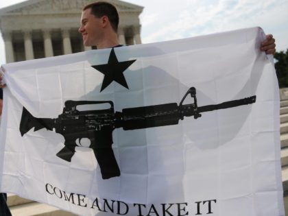 Gun rights activists celebrate the news from US Supreme Court June 26, 2008 that Americans have a constitutional right to bear arms, ending a ban on owning handguns in Washington, DC in its first ruling on gun rights in 70 years. The court's 5-4 landmark decision -- on whether the …