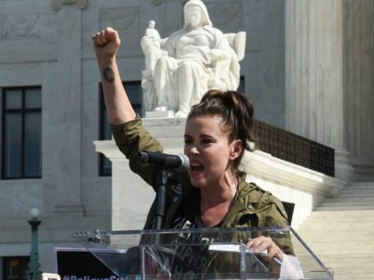 Actor Alyssa Milano speaks to demonstrators protesting against Judge Brett Kavanaugh's nomination as an Associate Justice on the Supreme Court in front of the Supreme Court in Washington, DC, September 28, 2018. - Kavanaugh's contentious Supreme Court nomination will be put to an initial vote Friday, the day after a …