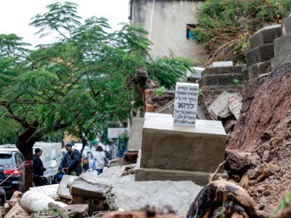 This picture taken on December 26, 2019 shows a grave dating back to 1942 that was damaged as it fell in a mudslide during bad weather in a winter storm at the Jewish cemetery in the Lebanese capital Beirut. - Entire grave stones spiled onto a street in the Lebanese …