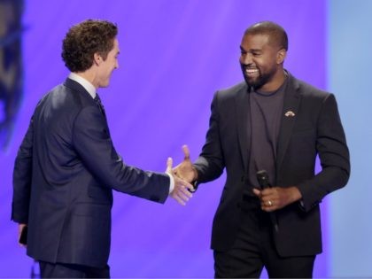 Kanye West, right, shakes hands with senior pastor Joel Osteen during a service at Lakewood Church, Sunday, Nov. 17, 2019, in Houston. (AP Photo/Michael Wyke)
