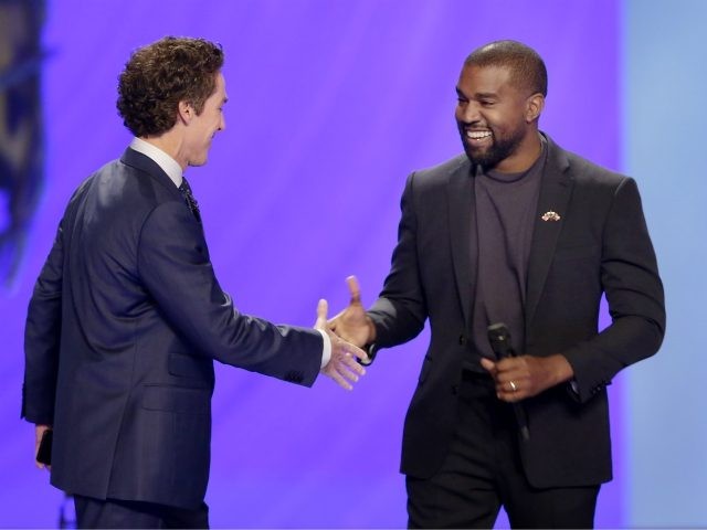 Kanye West, right, shakes hands with senior pastor Joel Osteen during a service at Lakewoo