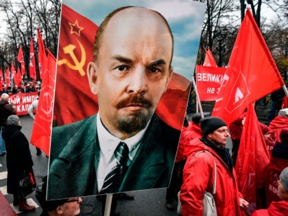 Russian Communist party supporters march in central Moscow with red flags and Lenin's potrait on November 7, 2019, marking the 102th anniversary of the October 1917 Bolshevik Revolution. (Photo by Alexander NEMENOV / AFP) (Photo by ALEXANDER NEMENOV/AFP via Getty Images)