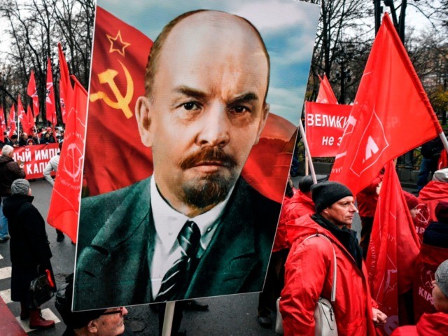 Russian Communist party supporters march in central Moscow with red flags and Lenin's potr