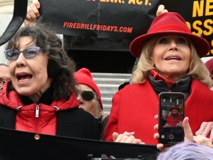 Actresses and activists Lily Tomlin (L) and Jane Fonda hold hands as they lead a climate protest on the steps of the US Capitol in Washington, DC on December 27, 2019. - The rally marked the 12th consecutive Friday that Jane Fonda has led protests in Washington, DC. The protests …