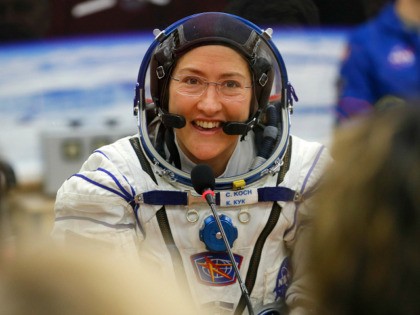 FILE - In this Thursday, March 14, 2019 file photo, U.S. astronaut Christina Koch, member of the main crew of the expedition to the International Space Station (ISS), speaks with her relatives through a safety glass prior the launch of Soyuz MS-12 space ship at the Russian leased Baikonur cosmodrome, …