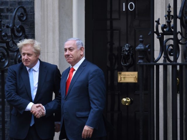 Britain's Prime Minister Boris Johnson (L) greets Israel's Prime Minister Benjamin Netanya