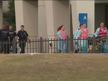 This photo taken from video provided by WEAR-TV shows emergency responders near the Naval Air Base Station in Pensacola, Fla., Friday, Dec. 6, 2019. The US Navy is confirming that an active shooter and one other person are dead after gunfire at the Naval Air Station in Pensacola. Area hospital …