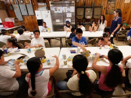 CHICAGO - JUNE 24: Children eat breakfast at the start of a day camp program at Casa Juan Diego St. Pius V Youth Center June 24, 2009 in Chicago, Illinois. The center provides free breakfast and lunch to about 90 children a day in the program. With 84 percent of …