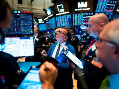 Traders work before the opening bell at the New York Stock Exchange (NYSE) on November 14, 2019 in New York City. - Global economic worries on Thursday caused Wall Street to retreat from record highs following sour economic data from major economies and signs of persistent deadlock in US-China trade …