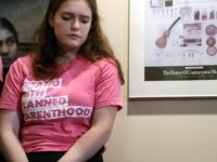 After taking a turn speaking about the medical services she's received there, Amelia, who declined to give her last name, listens during a news conference at a Planned Parenthood clinic addressing a change in rules on the nearly 50-year-old Title X family planning program, Thursday, Aug. 22, 2019, in Seattle. …