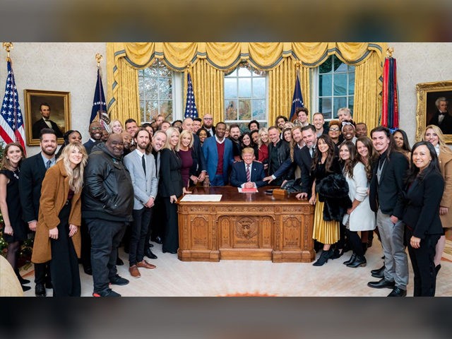 President Trump surrounded by a large group of worship leaders from across the country whom he invited to pray for him in the Oval Office Friday. (Official White House Photo by Tia Dufour)