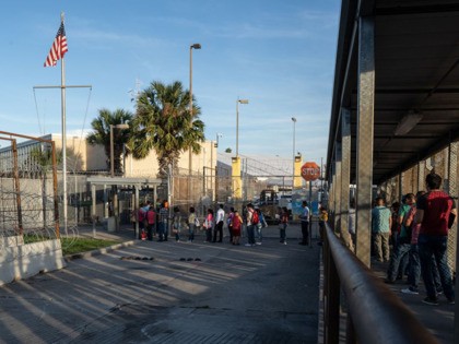 Dozens of people are seen waiting to enter the United States on the Northern side of the International Bridge over the Rio Grande, in Matamoros, Tamaulipas state, Mexico, on 05 November 2019. - There are around 2000 asylum seekers currently living in tents next to the International Bridge that connects …