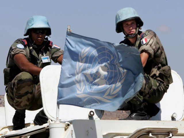 A UN flag flutters atop an armoured personnel carrier as UNIFIL French Foreign Legion soldiers observe the landscape during a patrol in the area outside the southern Lebanese border town of Ain Ebel, 05 September 2006. Lebanese troops should soon control their southern border for the first time in decades, …