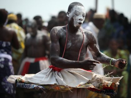 OUIDAH, BENIN - JANUARY 10: A Voodoo dancer performs during the Voodoo festival on January 10, 2012 in Ouidah, Benin. Ouidah is Benin's Voodoo heartland, and thought to be the spiritual birthplace of Voodoo or Vodun as it known in Benin. Shrouded in mystery and often misunderstood, Voodoo was acknowledged …