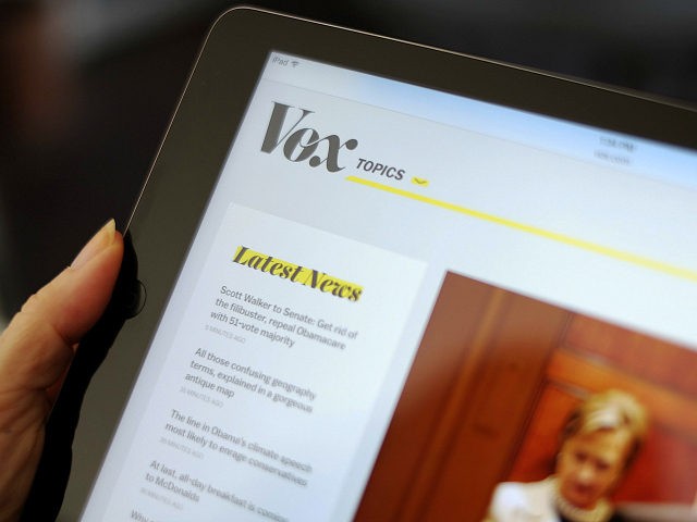 FILE - In this Sept. 1, 2015, file photo the Vox website is displayed on an iPad held by a