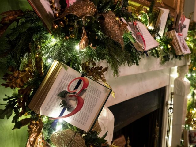 A fireplace mantle is decorated in the Green Room during the 2019 Christmas preview at the