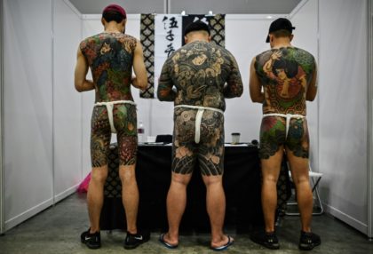 Malaysia slams tattoo expo as 'porn' over half-naked pics