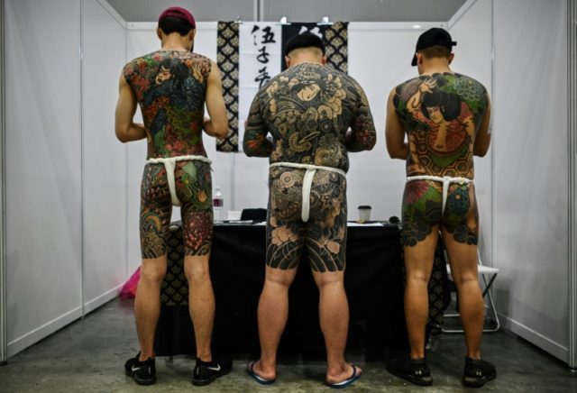 Malaysia slams tattoo expo as 'porn' over half-naked pics