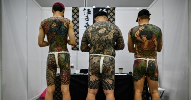 Malaysia slams tattoo expo as porn over half-naked pics