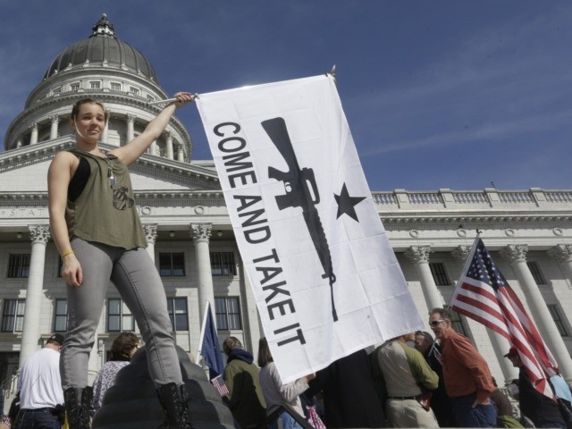 FILE - In this March 2, 2013, file photo, gun rights activist Holly Cusumano waves a flag during a rally for the 2nd Amendment at the Utah State Capitol in Salt Lake City. Legislators have sent Utah Gov. Gary Herbert a handful of gun bills that tighten and loosen oversight …