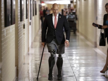 Rep. Brian Mast, R-Fla., walks to a meeting with fellow Republicans on Capitol Hill in Washington, Friday, July 14, 2017, to reconcile the GOP's long-overdue budget blueprint, even as divisions between moderates and conservatives over cutting programs like food stamps threaten passage of the measure. Mast, a combat veteran and …