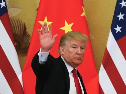 U.S. President Donald Trump waves after attending a joint press conference with Chinese Pr