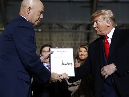 President Donald Trump shakes hands with Gen. Jay Raymond, after signing the letter of his appointment as the chief of space operations for U.S. Space Command during a signing ceremony for the National Defense Authorization Act for Fiscal Year 2020 at Andrews Air Force Base, Md., Friday, Dec. 20, 2019. …