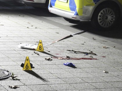 Markers placed on the ground inside cordoned-off area in front of a police station in Gels