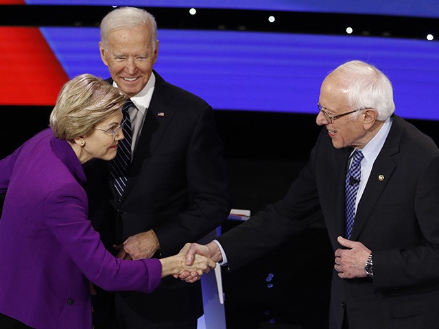 Democratic presidential candidates Sen. Elizabeth Warren, D-Mass., left, and Sen. Bernie Sanders, I-Vt., right greet each other as former Vice President Joe Biden, watches Tuesday, Jan. 14, 2020, before a Democratic presidential primary debate hosted by CNN and the Des Moines Register in Des Moines, Iowa. (AP Photo/Patrick Semansky)