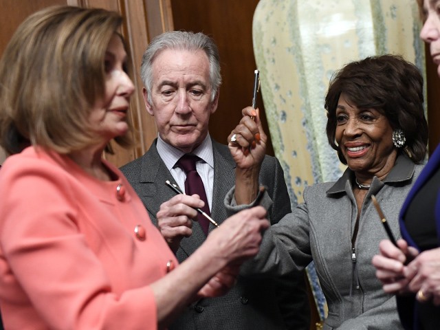 House Financial Services Committee Chairwoman Maxine Waters, D-Calif., holds up a pen presented to her by House Speaker Nancy Pelosi of Calif., after she signed the resolution to transmit the two articles of impeachment against President Donald Trump to the Senate for trial on Capitol Hill in Washington, Wednesday, Jan. 15, 2020. At left, is House Intelligence Committee Chairman Adam Schiff, D-Calif., House Ways and Means Committee Chairman Richard Neal, D-Mass., and Rep. Zoe Lofgren, D-Calif., right. (AP Photo/Susan Walsh)