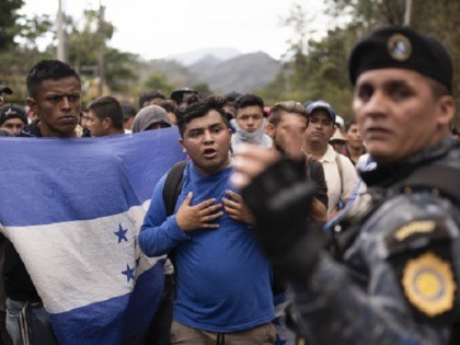 Honduran migrants walking in a group stop before Guatemalan police near Agua Caliente, Guatemala, Thursday, Jan. 16, 2020, on the border with Honduras. Less-organized migrants, tighter immigration control by Guatemalan authorities and the presence of U.S. advisers have reduced the likelihood that the hundreds of migrants who departed Honduras will …