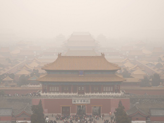Tourists exit the Forbidden City in Beijing, Saturday, Jan. 18, 2020. A Chinese woman spar