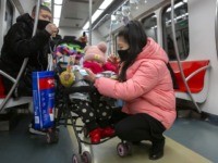 People wearing face masks attend to a child in a stroller as they ride a subway train in Beijing, Sunday, Jan. 26, 2020. The new virus accelerated its spread in China, and the U.S. Consulate in the epicenter of the outbreak, the central city of Wuhan, announced Sunday it will …
