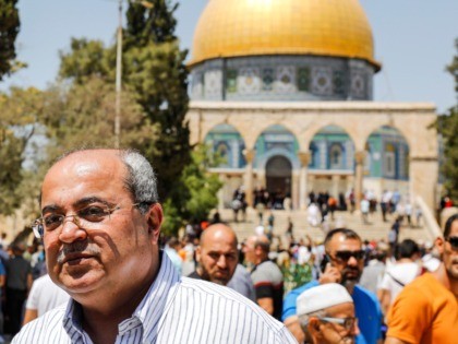 Ahmed Tibi (R), Israeli-Arab politician and leader of the Arab Movement for Change party, poses for a picture with a man using his phone to take a "selfie", as he stands at the Aqsa mosque compound in the Old City of Jerusalem on August 16, 2019, with the Dome of …