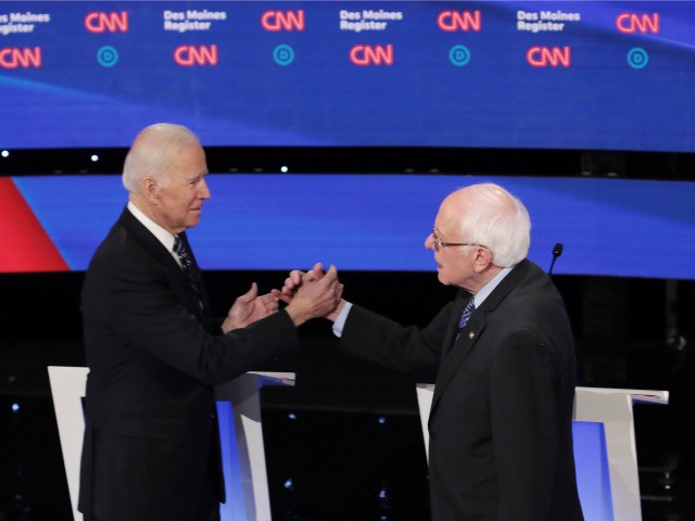 Former Vice President Joe Biden (L) greets Sen. Bernie Sanders (I-VT) before the Democrati