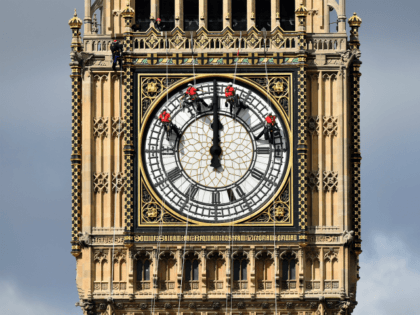 Technicians carry out cleaning and maintenance work on one of the faces of the Great Clock