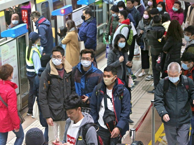 People wear masks at a metro station in Taipei, Taiwan, Tuesday, Jan. 28, 2020. According