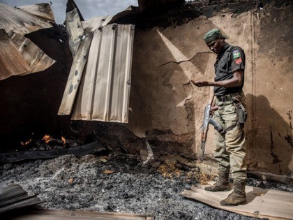 A Nigerian Police Officer patrols an area of destroyed and burned houses after a recent Fulani attack in the Adara farmers' village of Angwan Aku, Kaduna State, Nigeria on April 14, 2019. - The ongoing strife between Muslim herders and Christian farmers, which claimed nearly 2,000 lives in 2018 and …