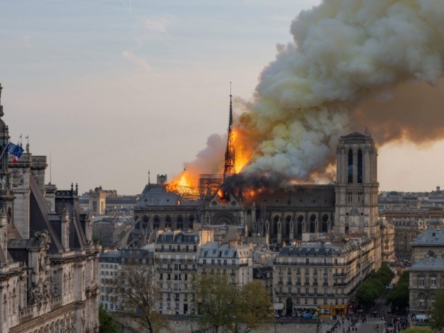 TOPSHOT - Smoke billows as flames burn through the roof of the Notre-Dame de Paris Cathedr