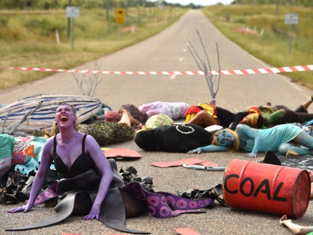 TOPSHOT - In this photo taken on May 1, 2019 shows environmental campaigners holding a protest against the development of the India-backed Adani coal mine at the entrance of Abbot Point port near the Queensland state town of Bowen, where the commodity will be shipped. - Tackling climate change has …