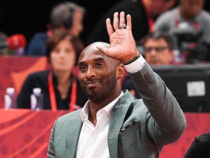 Former basketball player Kobe Bryant of the US waves at the crowd during the Basketball World Cup semi-final game between Australia and Spain in Beijing on September 13, 2019. (Photo by Greg BAKER / AFP) (Photo by GREG BAKER/AFP via Getty Images)