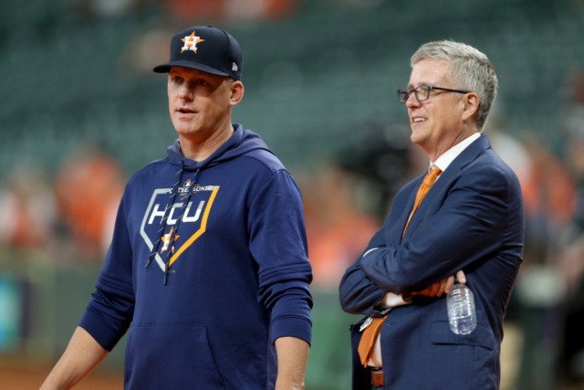 HOUSTON, TEXAS - OCTOBER 05: Manager AJ Hinch #14 talks with Jeff Luhnow, General Manager
